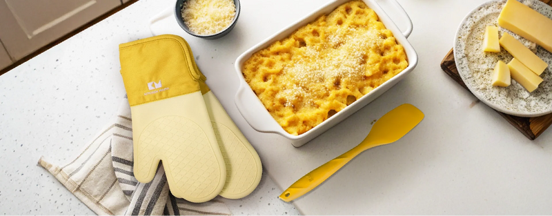 Creamy baked mac and cheese with Kitchen Mama oven mitts and a silicone spatula