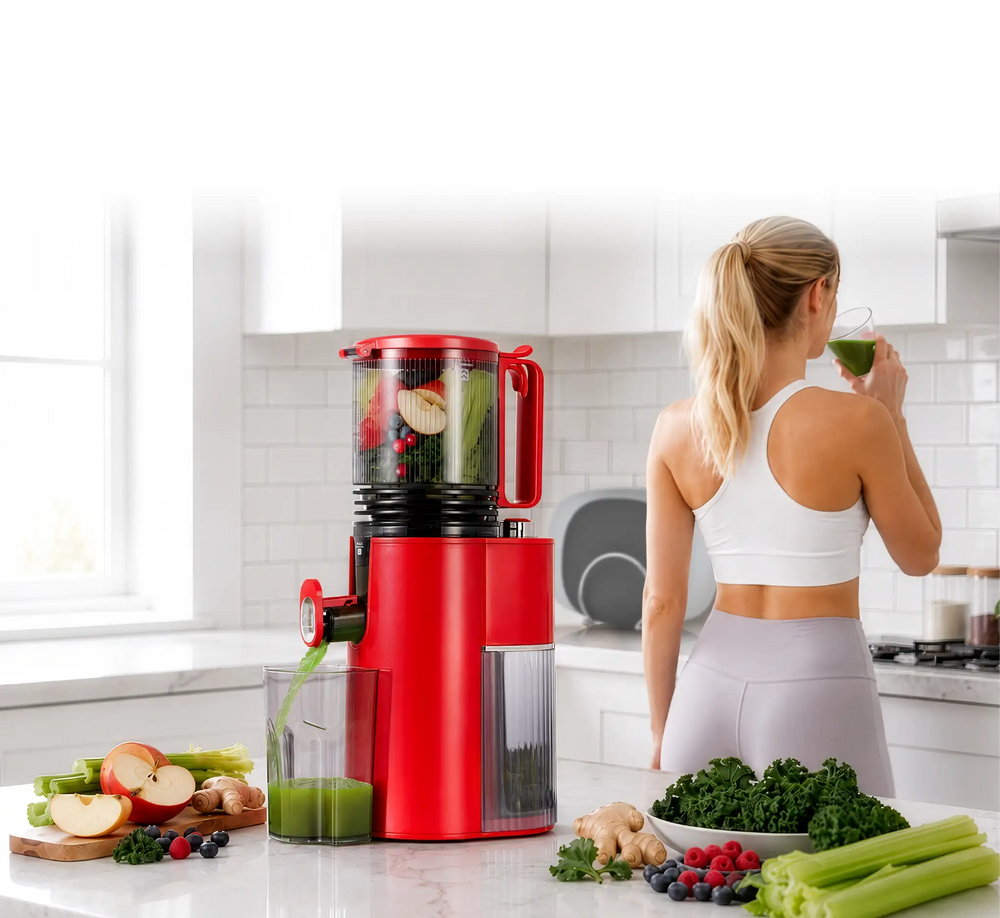 Kitchen Mama EverVive cold press juicer making fresh green juice with fruits and vegetables in a bright kitchen.